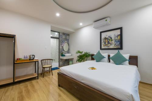 - une chambre avec un lit, une table et une chaise dans l'établissement Onion Homestay, à Hội An