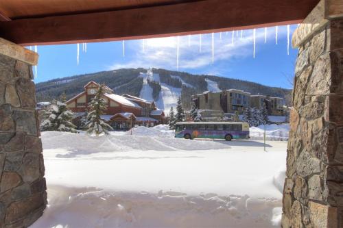 a bus parked in front of a building with snow at Copper Springs 132 in Frisco