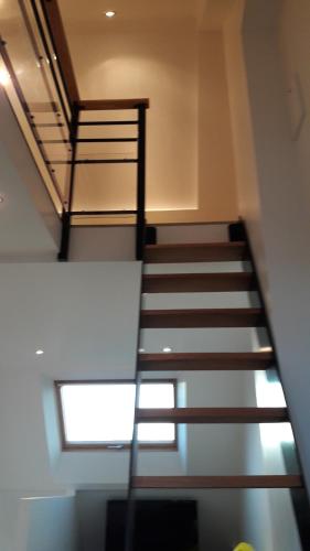 a spiral staircase in a building with a window at Abri du pêcheur in Étel