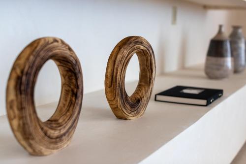 two wooden handles sitting on a counter with vases at Nobu Hotel Los Cabos in Cabo San Lucas