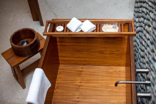 a wooden table with towels and a sink in a room at Nobu Hotel Los Cabos in Cabo San Lucas