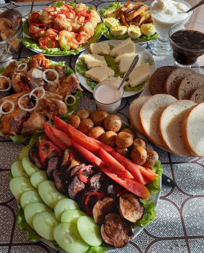a table topped with lots of different types of food at Apartments on Akhalubani St 2 in Tbilisi City