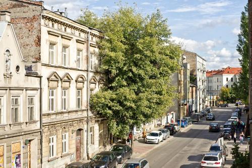 a city street with cars parked next to a building at Smart Rooms for Rent in Krakow