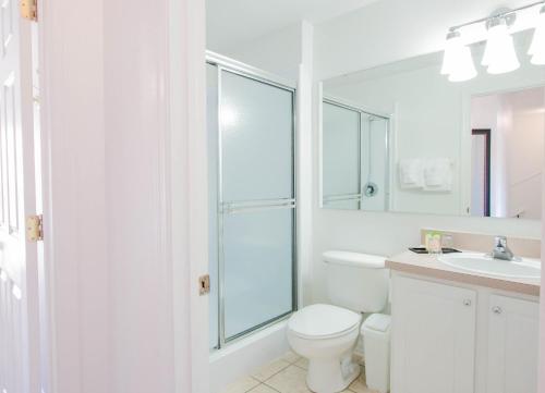 a white toilet sitting next to a white sink at Berkley Lake Townhomes in Kissimmee