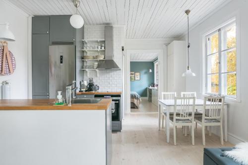a kitchen and dining room with a table and chairs at Peaceful, Picturesque Lake & Forest Retreat in Stockholm