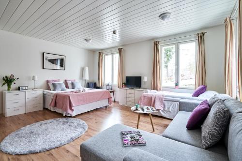 a living room with two beds and a couch at Guest House Porvoo in Porvoo