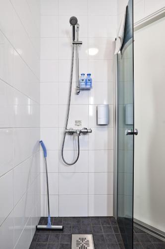 a shower in a bathroom with a glass door at Guest House Porvoo in Porvoo