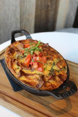 a pizza in a pan sitting on a cutting board at Radisson Blu Mall of America in Bloomington