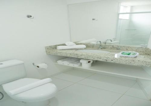 a white bathroom with a toilet and a sink at BRISTOL EASY HOTEL - RIO BONITO in Rio Bonito