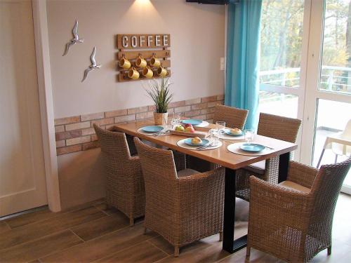 a dining room with a table and chairs at Apartament Comfort in Trzęsacz