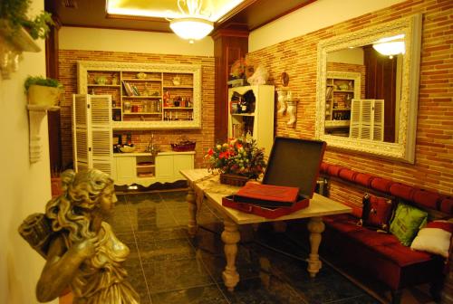 a living room with a couch and a table with a laptop at 2 KITARRAT Boutique Hotel & SPA in Durrës