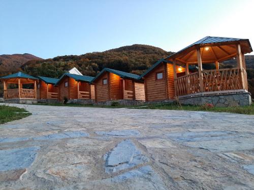 a row of wooden cabins in a resort at Ethno House Bektesevic in Gusinje