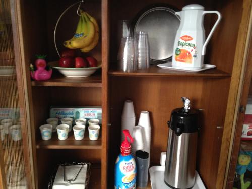 a cupboard with a coffee maker and other kitchen items at INN LEATHER GUEST HOUSE-GAY MALE ONLY in Fort Lauderdale