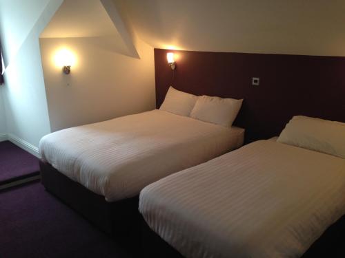 A bed or beds in a room at Hill View Hotel