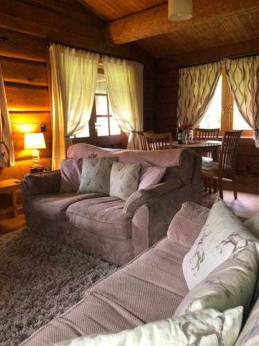 a living room with a couch and a table at Log home village in Ulverston