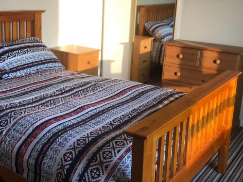 a bedroom with a wooden bed and a dresser at Travellers Rest in Launceston