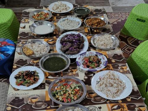 a table topped with plates of food and rice at Luxor hotel Bella Vista Apartments and Hotel in Luxor
