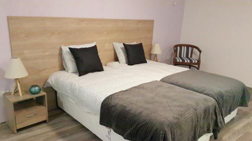 een slaapkamer met een groot bed en een stoel bij Art House Plovdiv in Plovdiv