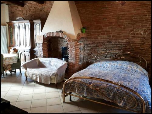 a bedroom with a bed and a brick wall at Taverna rustica in Toscana in Fucecchio