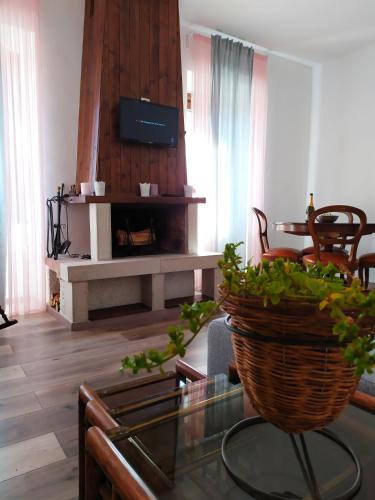 a living room with a glass table and a fireplace at Casa Violina in San Pietro Avellana