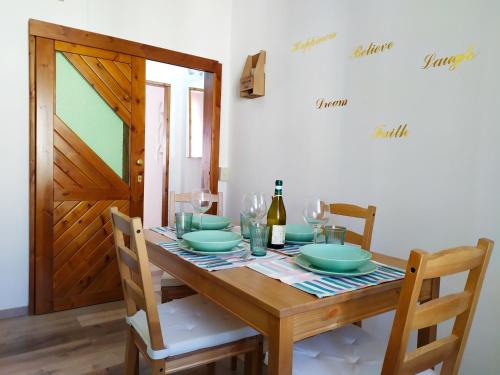 a dining room table with a wooden table and chairs at Casa Violina in San Pietro Avellana