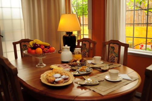 - une table en bois avec de la nourriture et un bol de fruits dans l'établissement Optimus BA, à Buenos Aires