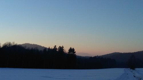 a snow covered field with trees in the distance at Novohradský ráj aneb Oáza klidu na samotě u lesa in Benešov nad Černou