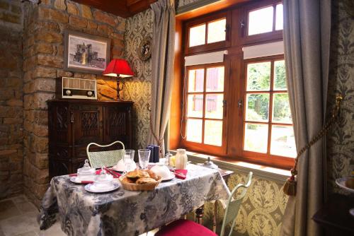 a table with a basket of food on it at La Minauderie in &Eacute;cully