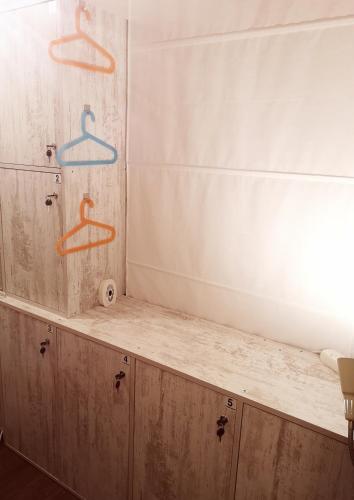 a bathroom counter with two hangers on the wall at PIJAMA HOUSE - Bike & Bed in Plovdiv