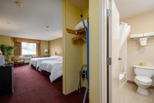 Habitación de hotel con cama y aseo en Three Rivers Inn Sedro Woolley, en Sedro-Woolley