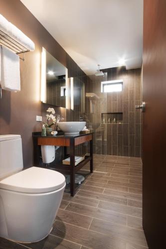a bathroom with a toilet and a sink at Bacau Bay Resort Coron in Coron