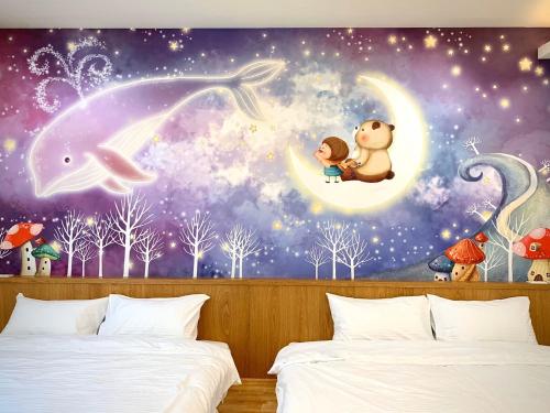 a bedroom with a wall mural of a child and a cat on the moon at Coral Island in Xiaoliuqiu