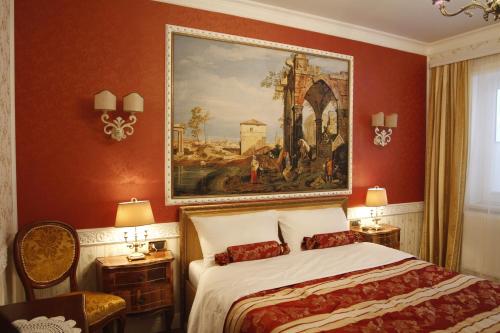 a bedroom with a large painting above a bed at Villa-Angelina in Langenzersdorf