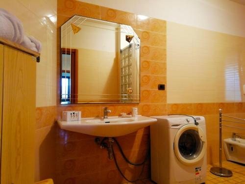a bathroom with a sink and a washing machine at B&B Maison Villa Vittorio in Avella