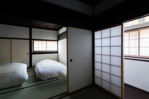 Una cama o camas en una habitación de 古民家の宿 Solii