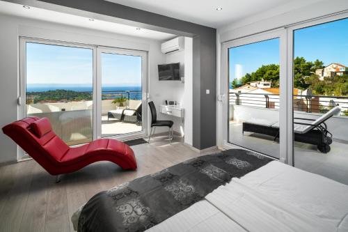 a bedroom with a bed and a view of the ocean at Villa Palladium in Makarska