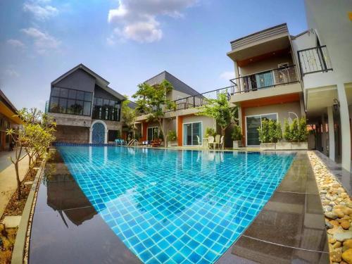 a swimming pool in front of a house at Aenguy Hostel in Sukhothai