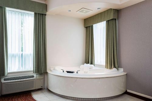 a bath tub in a room with a window at Best Western Inn On The Bay in Owen Sound
