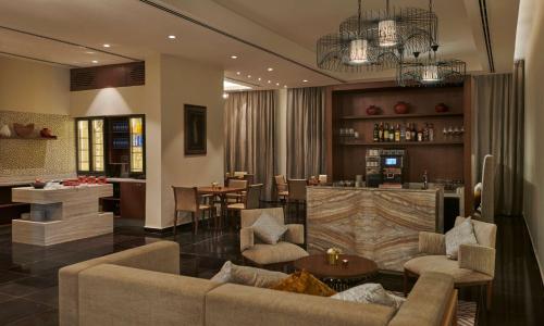 a living room with a couch and a bar at Hyatt Regency Addis Ababa in Addis Ababa
