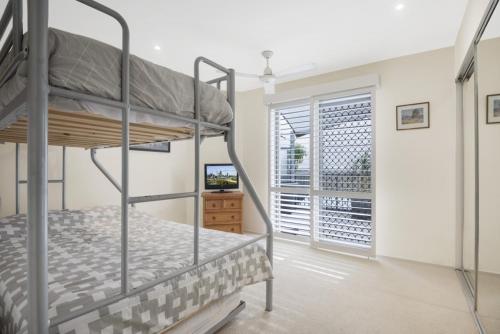 a bedroom with two bunk beds and a window at Breakwater Views by Kingscliff Accommodation in Cabarita Beach