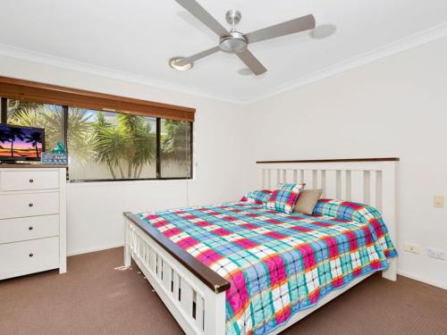 a bedroom with a bed and a ceiling fan at Casuarina Escape by Kingscliff Accommodation in Casuarina