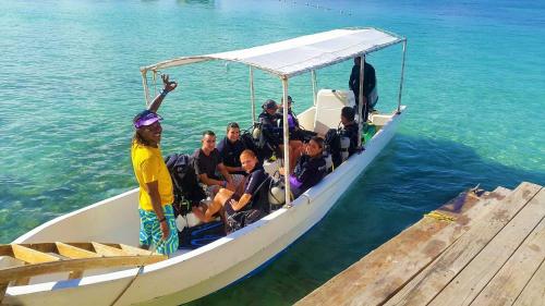 a group of people on a boat in the water at Fosters West Bay Resort in West Bay