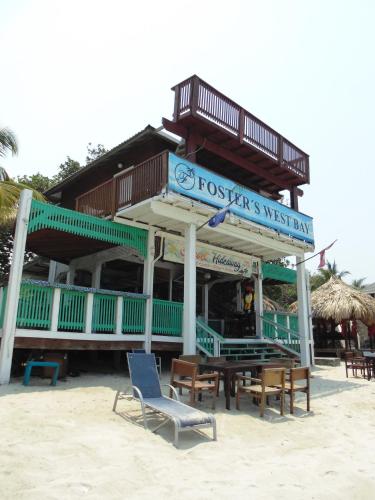 a restaurant on the beach with a table and chairs at Fosters West Bay Resort in West Bay