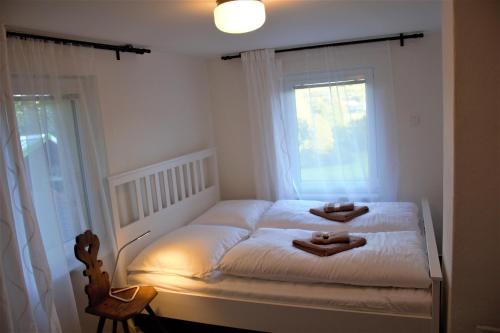 a small bedroom with a bed with two candles on it at Babiččin Vejminek in Čeladná