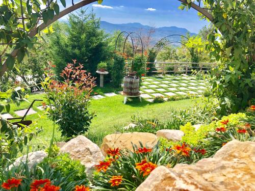 a garden with colorful flowers and a fence at Villa Aurora in Villanova del Battista