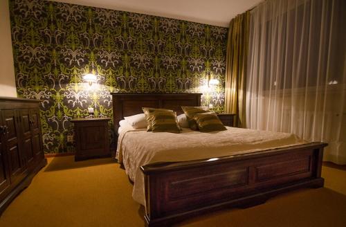 a bedroom with a bed with two pillows on it at Hotel Kamena in Chełm