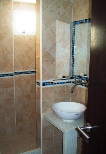 a bathroom with a sink and a shower at Ayres Sur in Mar del Plata