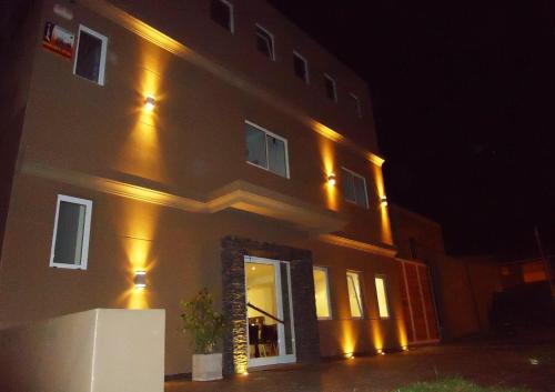 a building with lights on the side of it at night at Ayres Sur in Mar del Plata