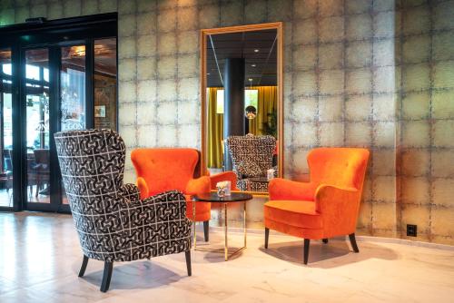a group of chairs and a table in a lobby at Thon Hotel Harstad in Harstad