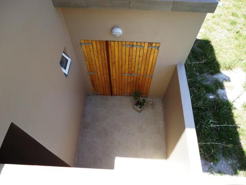 an overhead view of a staircase with a wooden door at Ayres Sur in Mar del Plata